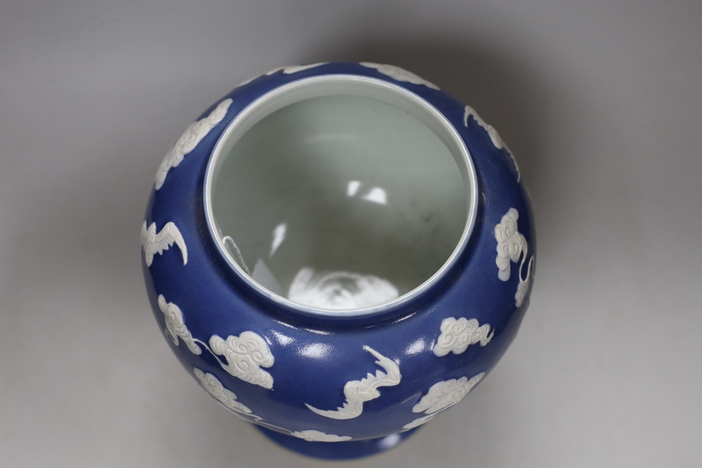 A Chinese slip-decorated blue glazed 'bats' vase 24cm